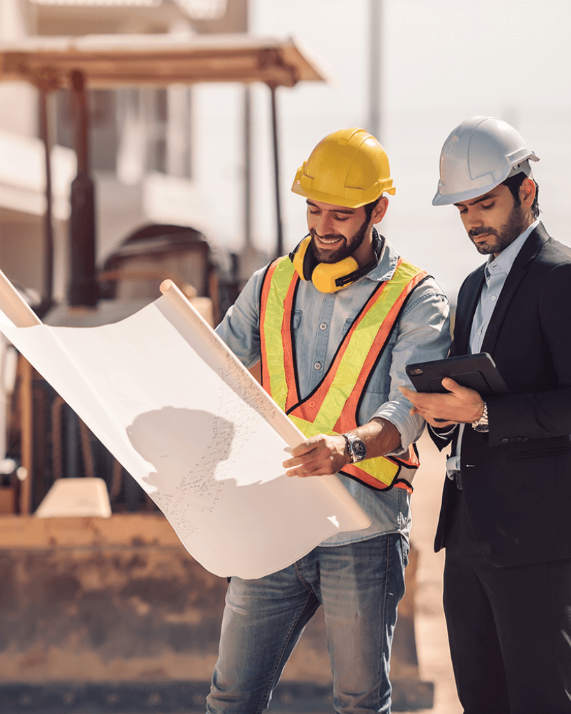 civil-engineer-construction-worker-manager-holding-digital-tablet-blueprints-talking-planing-about-construction-site-cooperation-teamwork-concept
